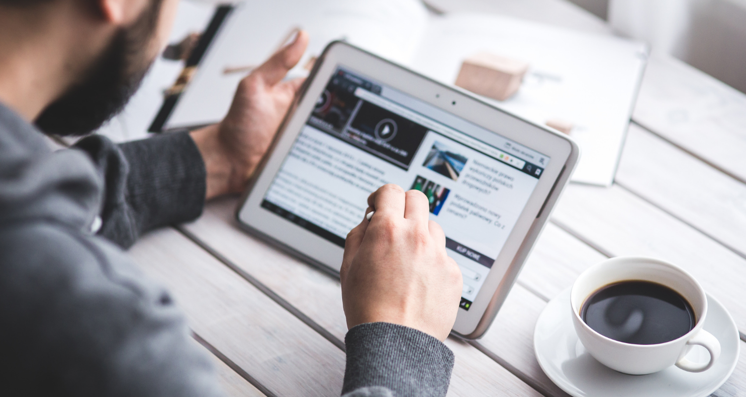 A person is reading online content on a tablet