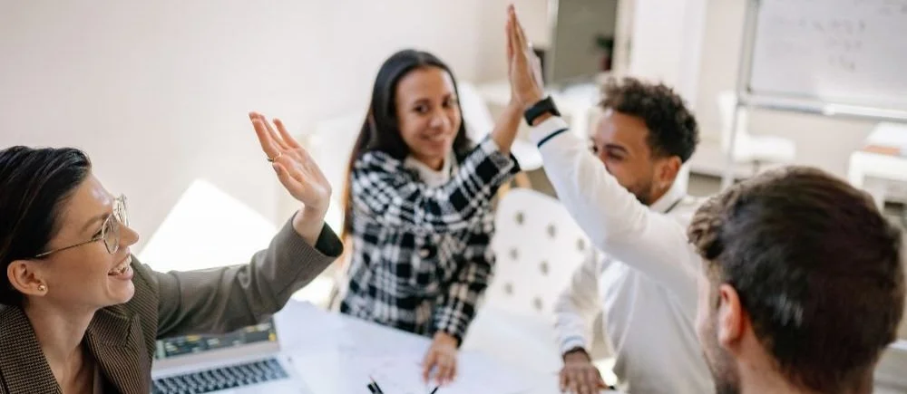 The marketing team celebrates a success together at the office