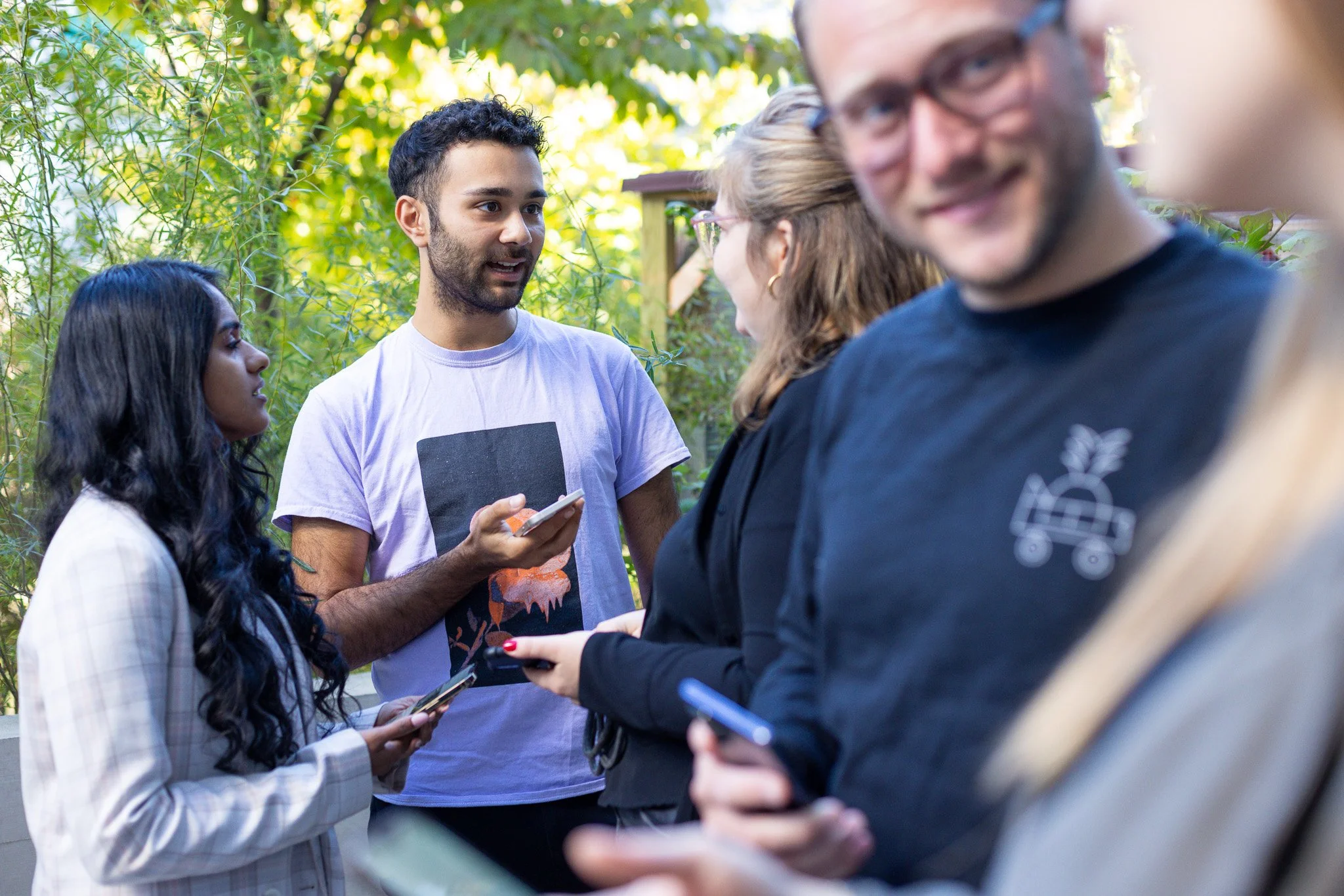Young employees of onlineKarma chatting outdoors