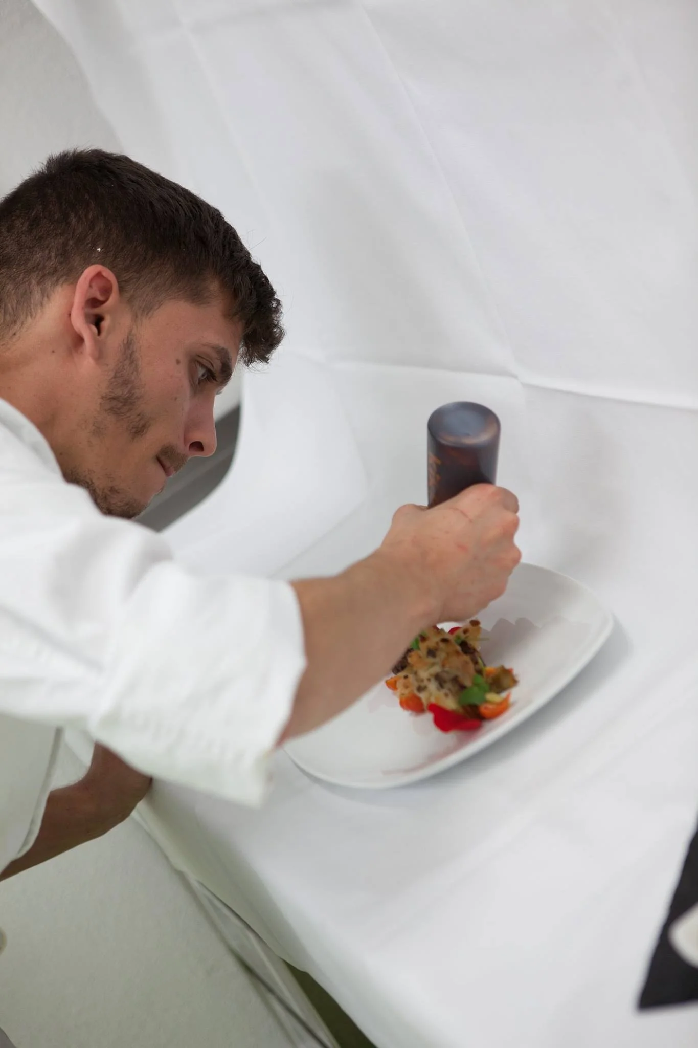 A chef prepares a dish at the Landhof restaurant in Basel