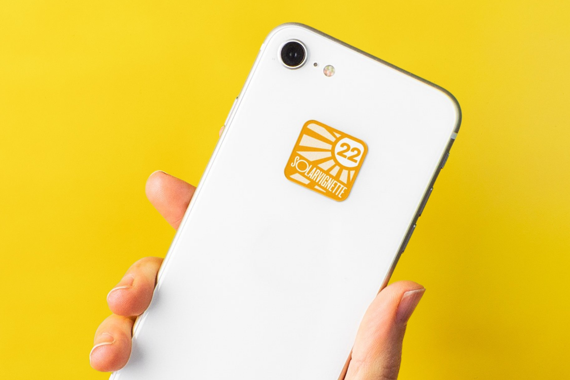 Cell phone with the 2022 solar sticker on a yellow background