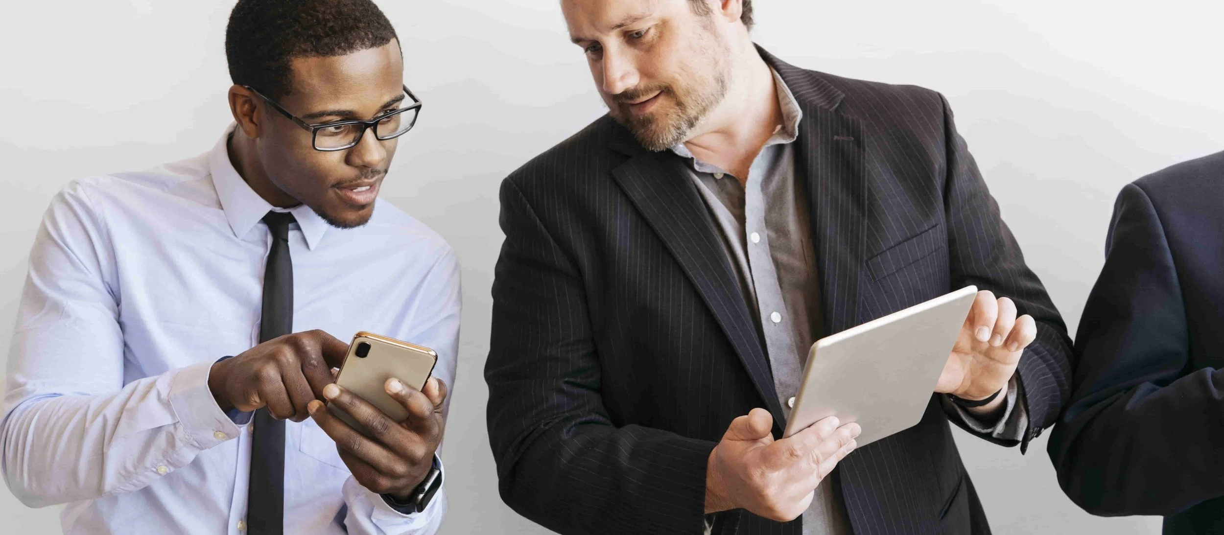Businesspeople use smartphones and tablets