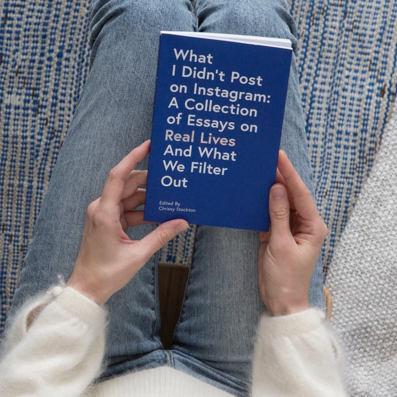 A person is holding a book about content not posted on Instagram