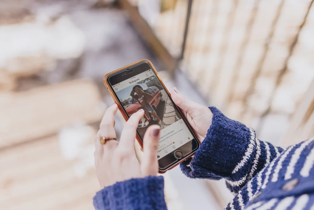 A person is looking at Instagram on a smartphone