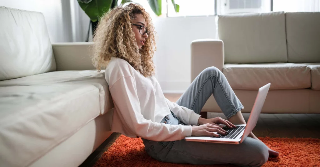 A woman works at home on a laptop