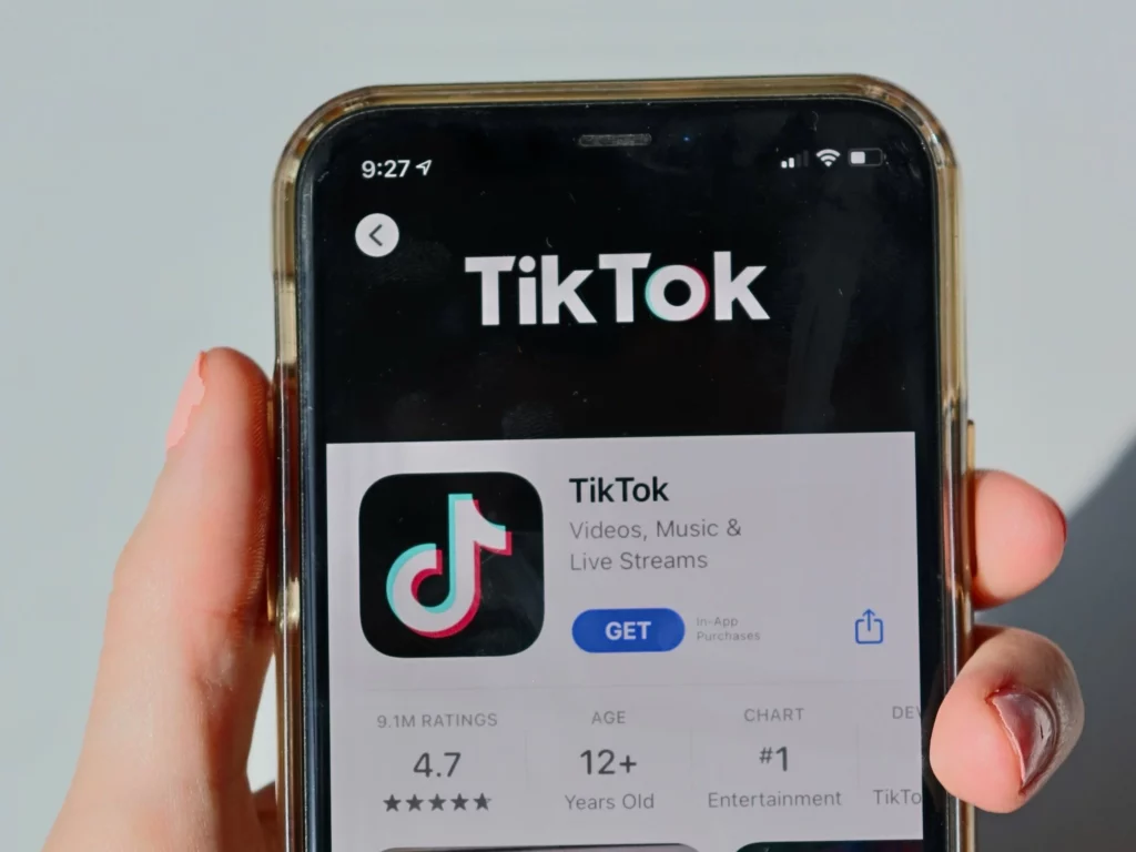 A smartphone with the TikTok page open in the App Store.