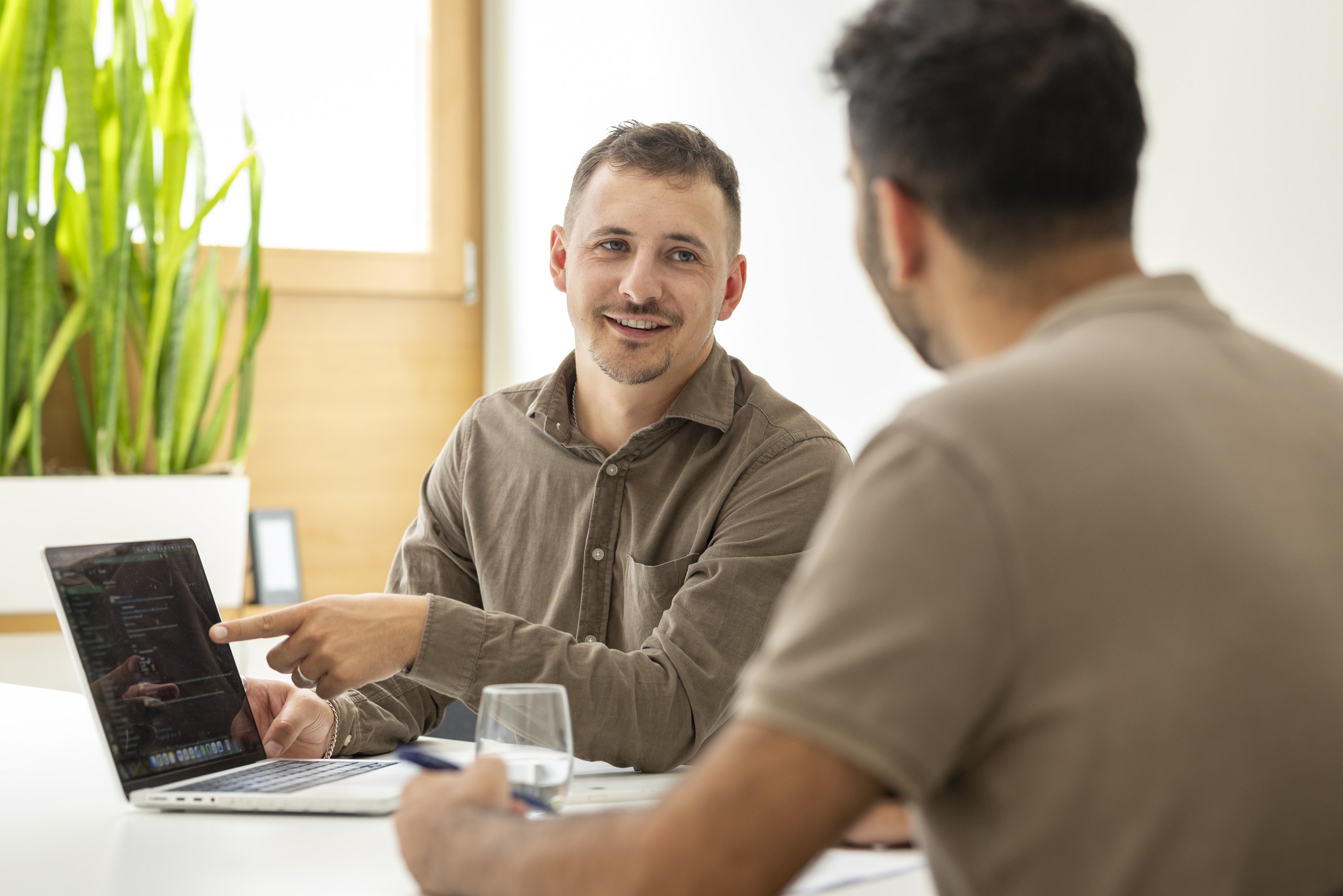 Two onlineKarma employees discussing a digital project at a table