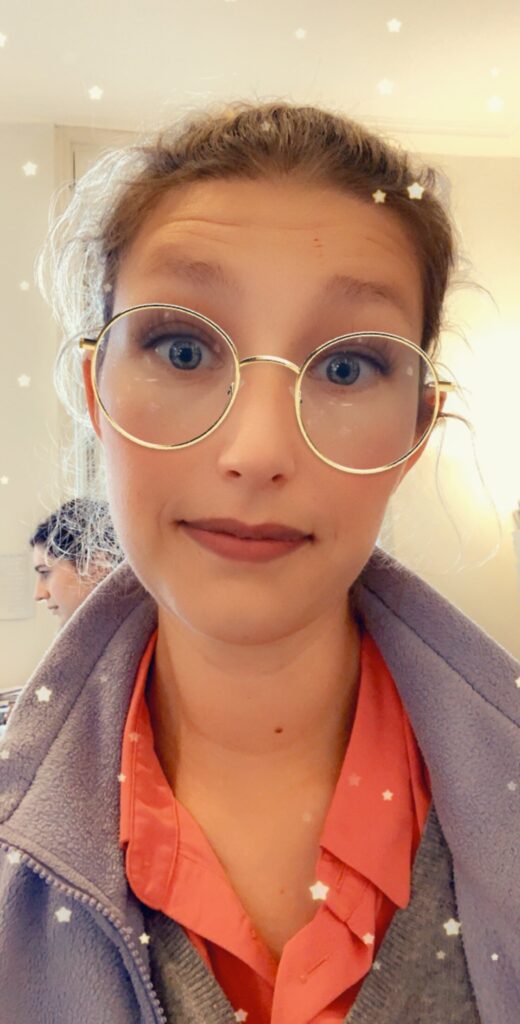 Woman with round glasses and a star Snapchat filter