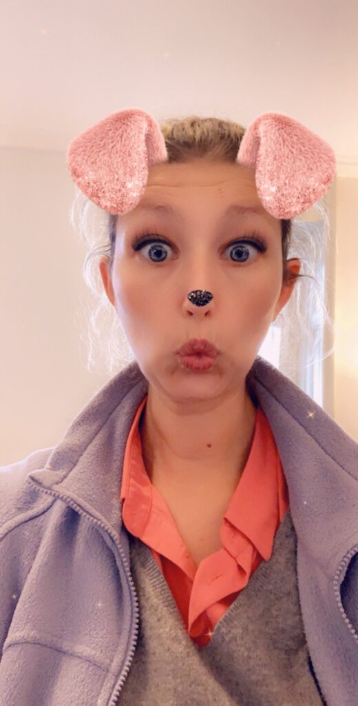 Woman with a Snapchat filter featuring dog ears and a dog's nose