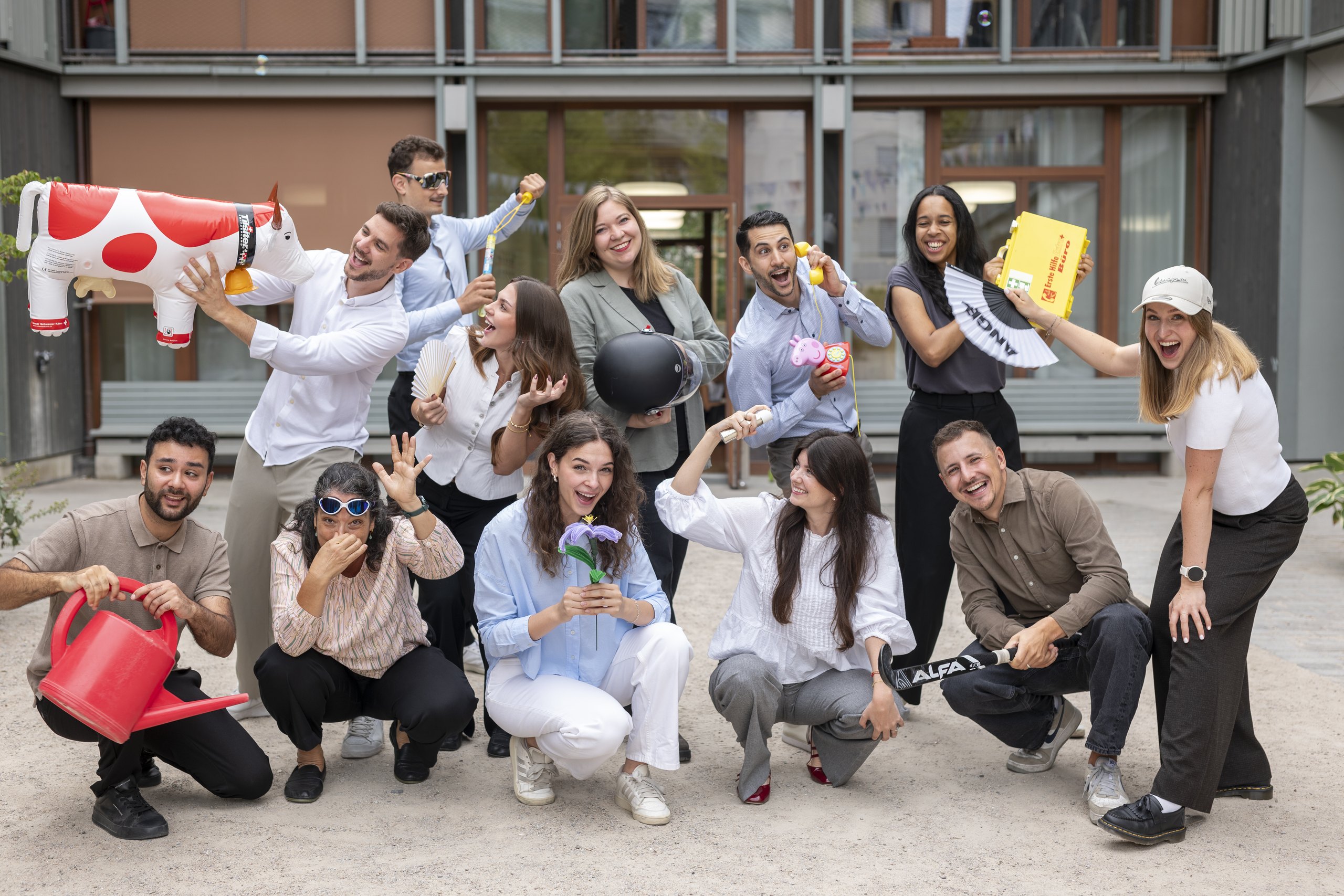 The onlineKarma team with colourful props outside the office building
