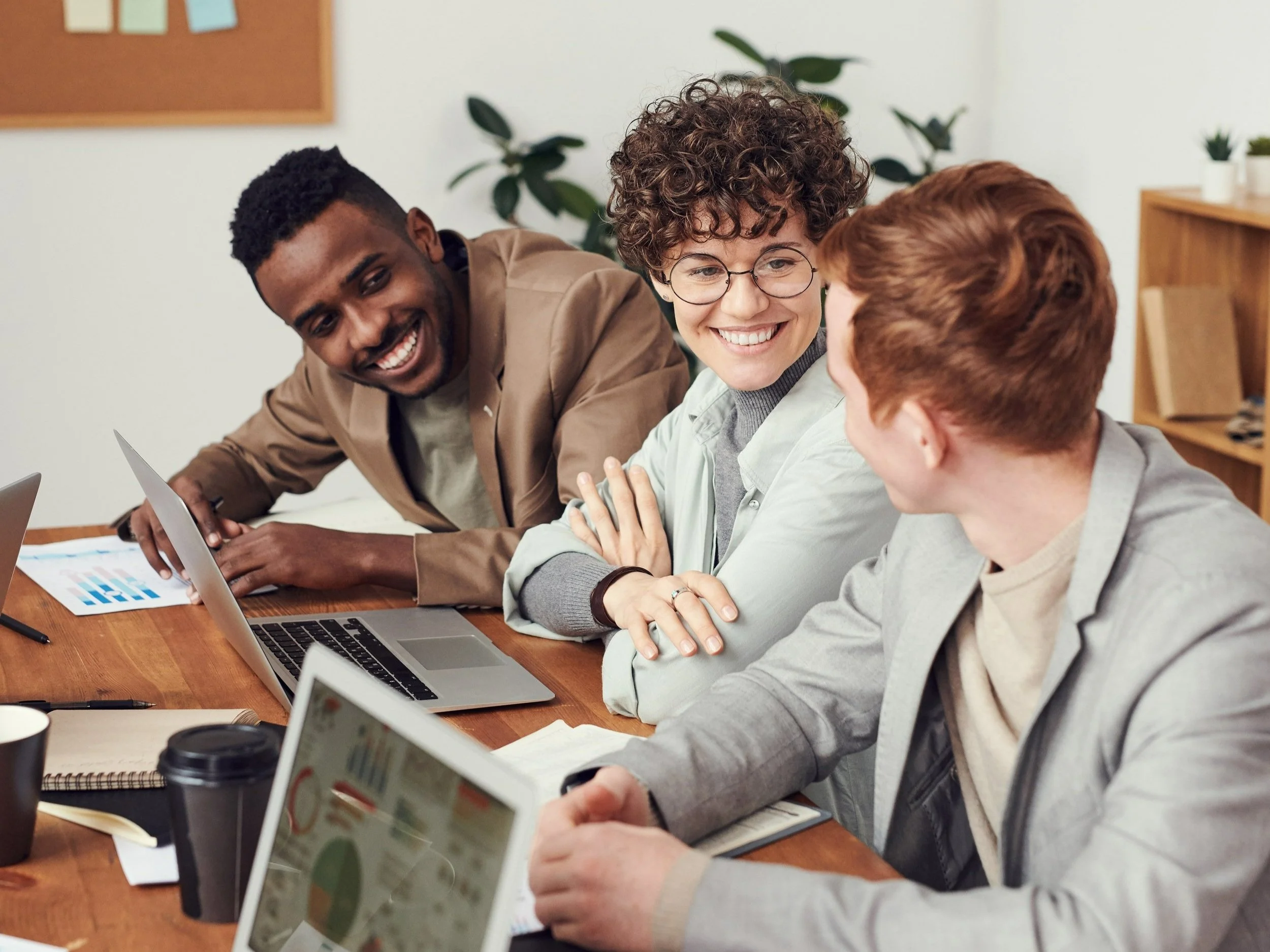 Three people are discussing a project together