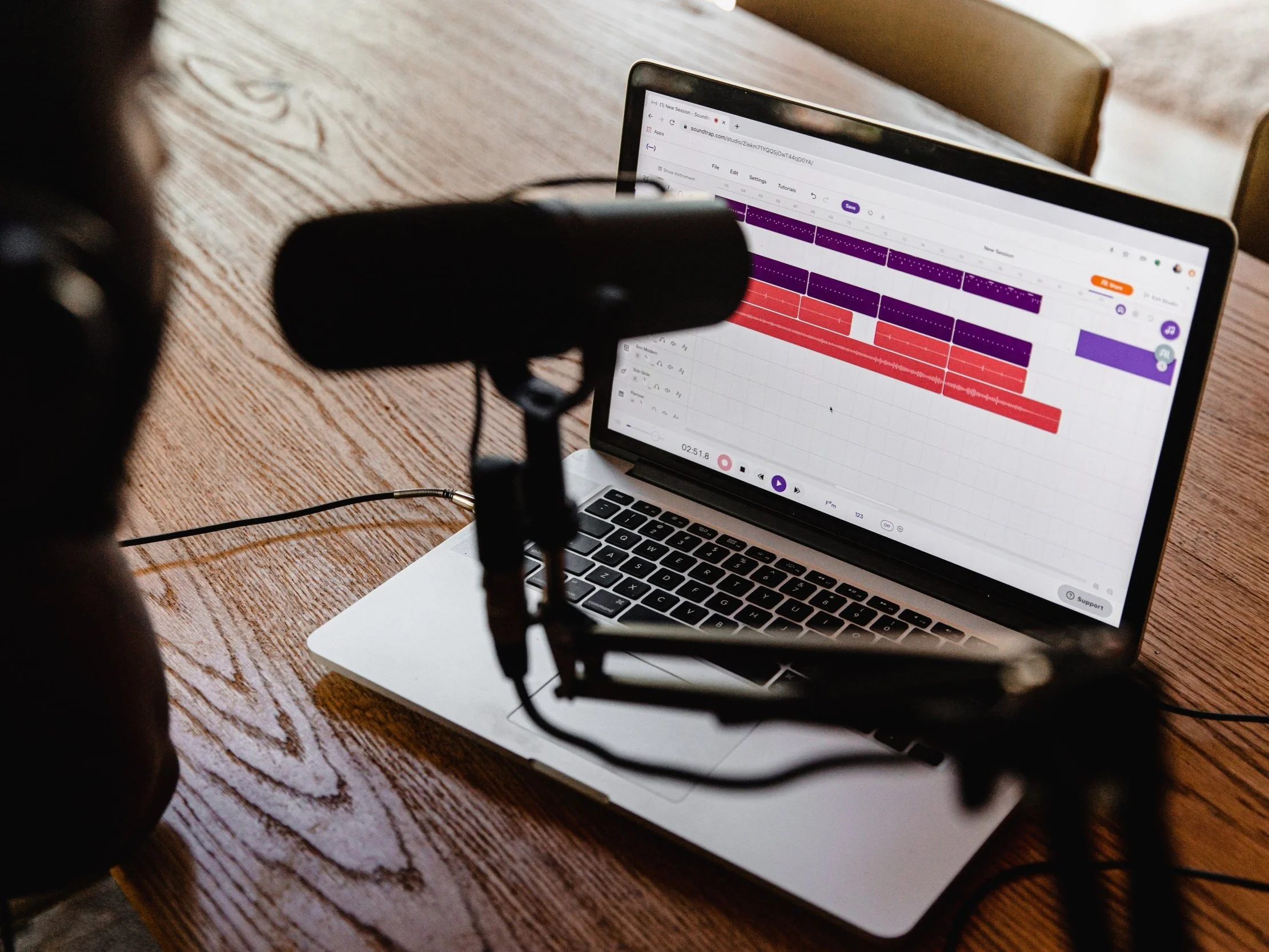 A microphone in front of a laptop with the audio recording feature open.