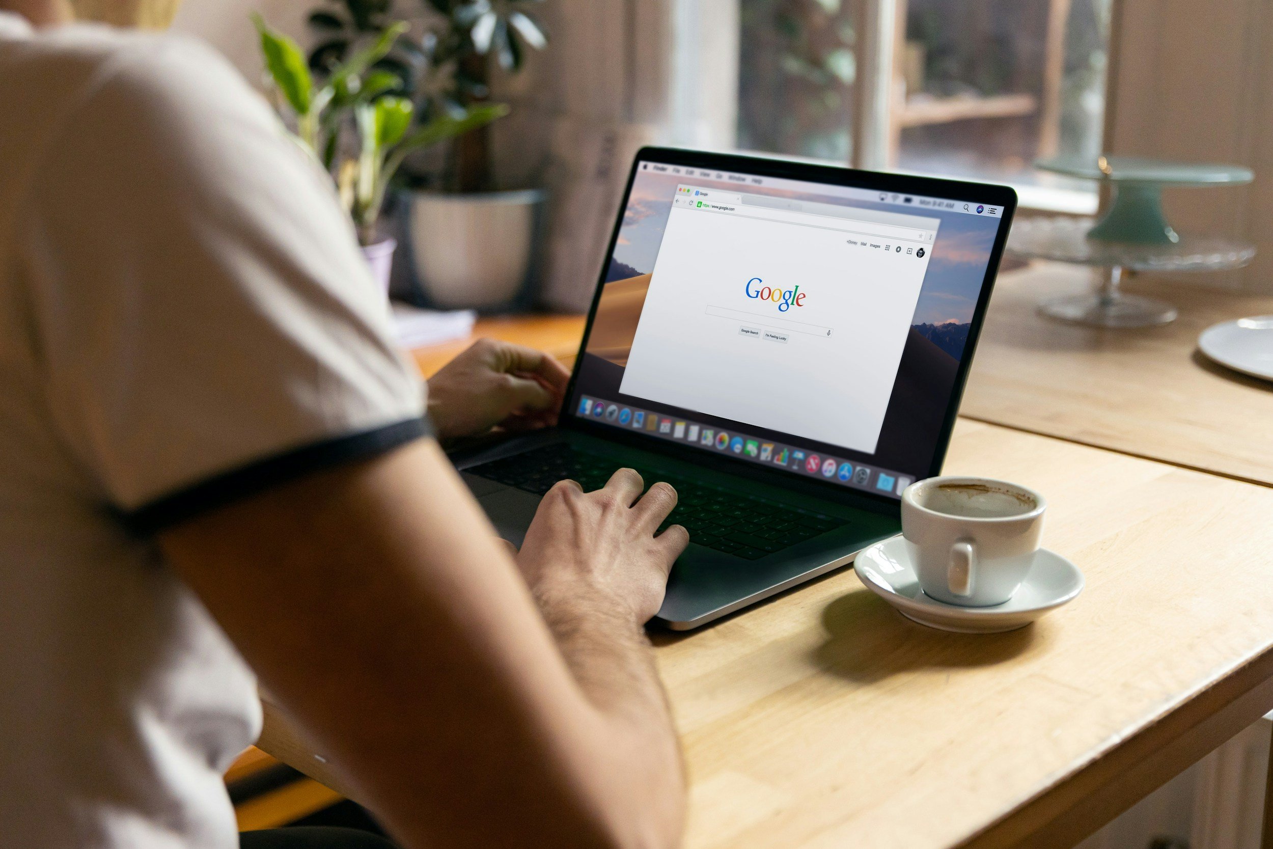 A person is using Google Search on a laptop