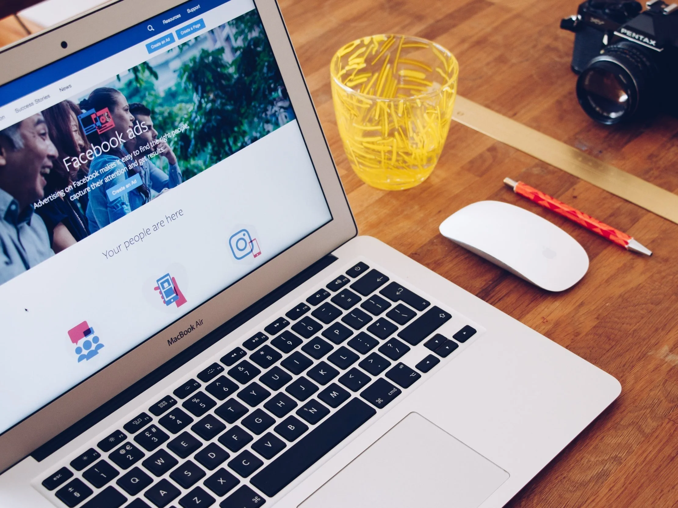A laptop with the Facebook Ads page open on a desk.